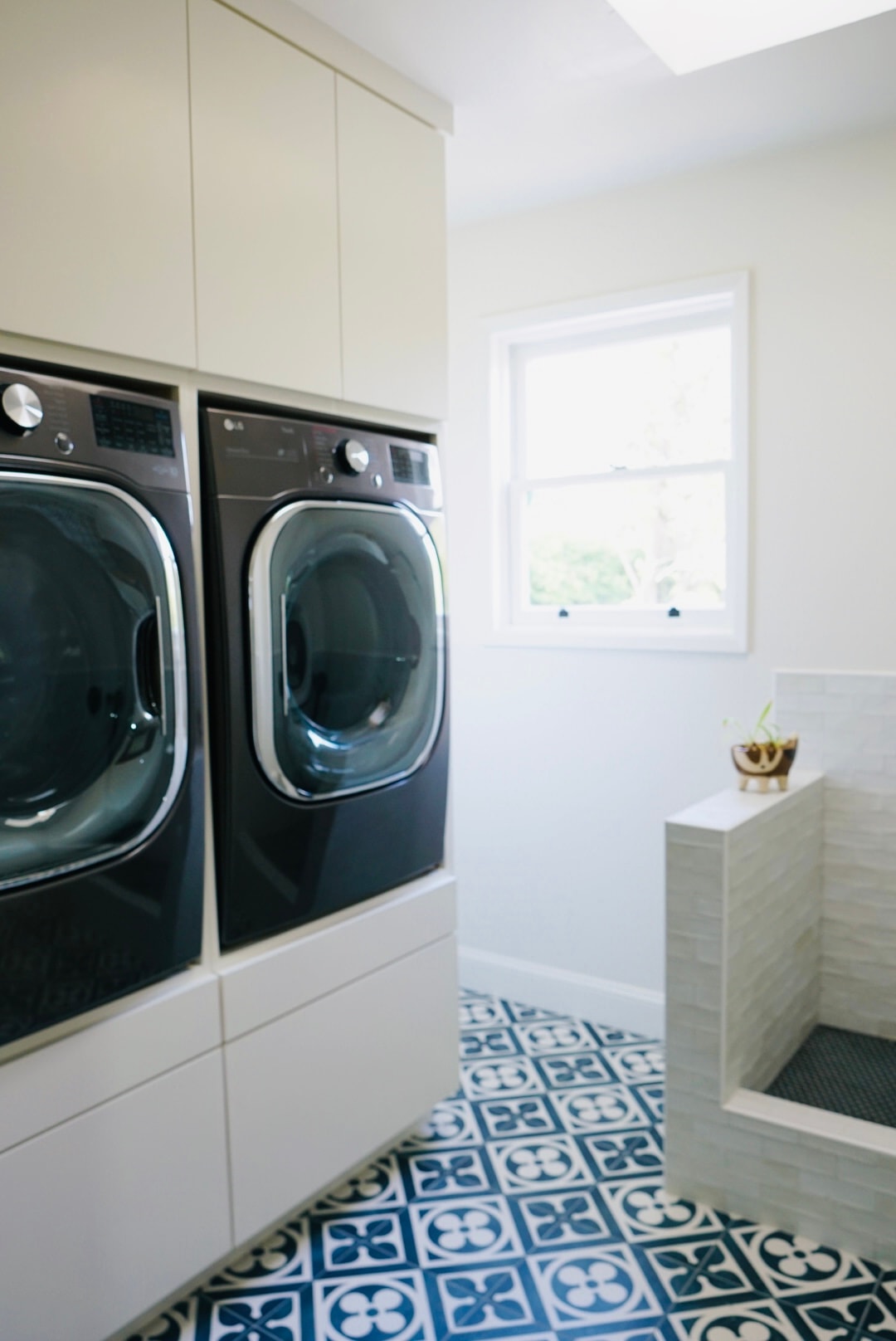 Blue laundry room with tile